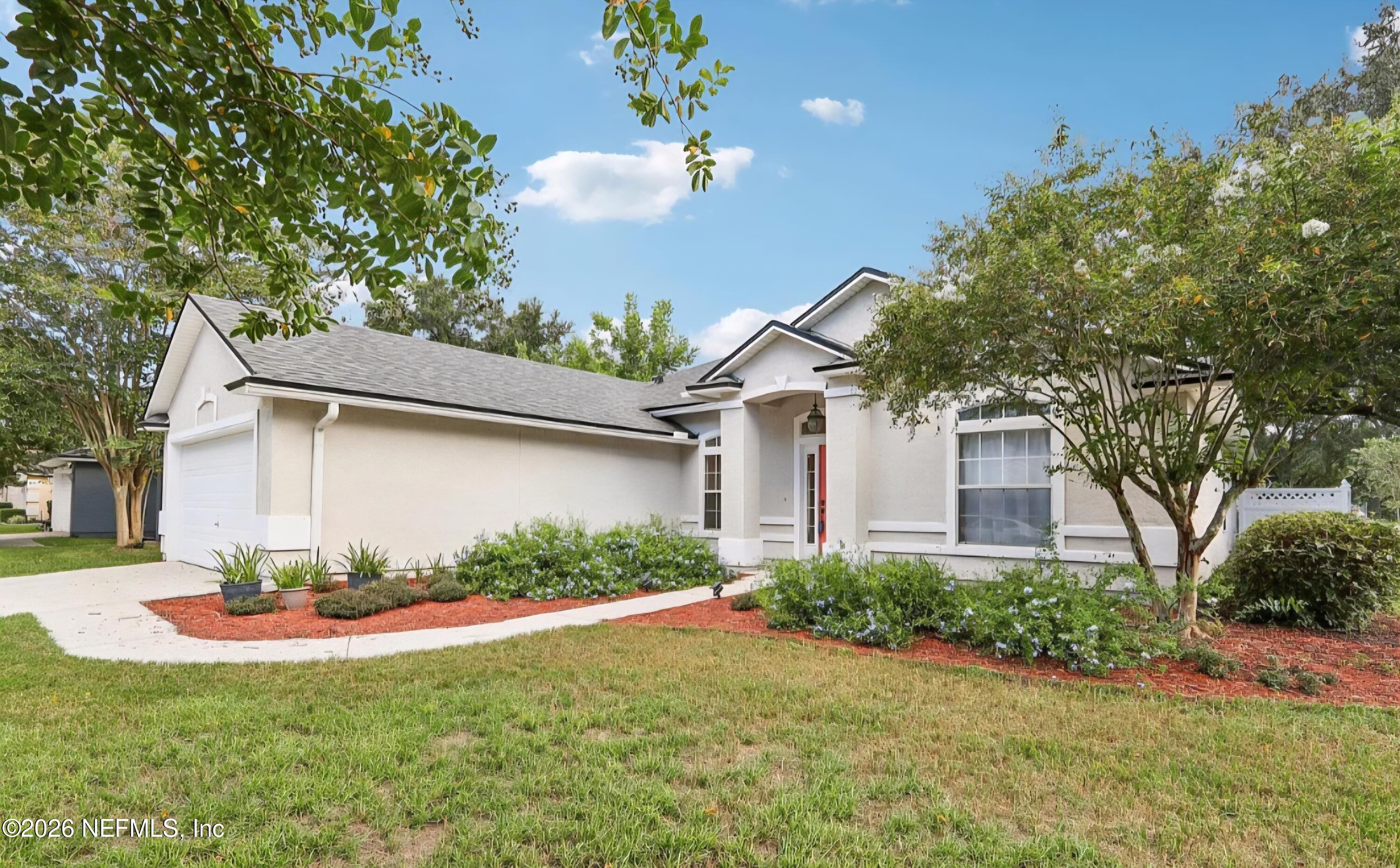 1001 Andrea Way St. Johns, FL 32259 - Photo 3 of 61 a front view of a house with a yard and garage