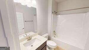 233 Carsons Walk Macon, GA 31206 - Photo 14 of 15 a bathroom with a sink toilet and shower