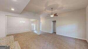 233 Carsons Walk Macon, GA 31206 - Photo 4 of 15 en empty room with a chandelier fan and a rug