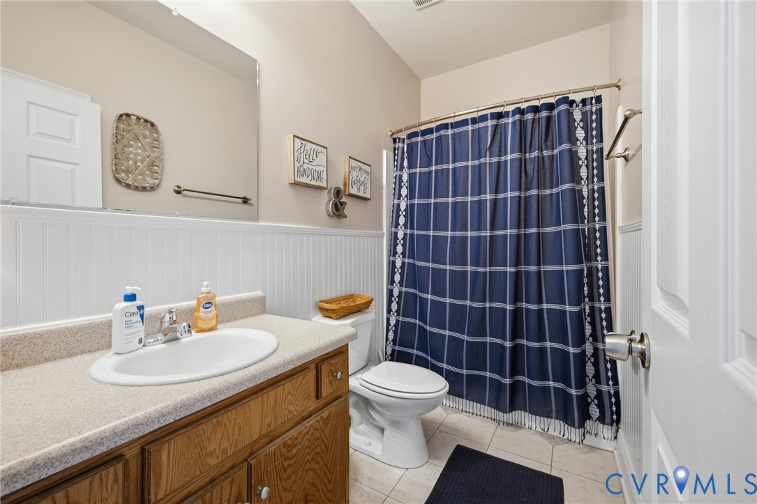 9433 Robin Road Disputanta, VA 23842 - Photo 17 of 26 Bathroom featuring a wood-finish vanity with an in
