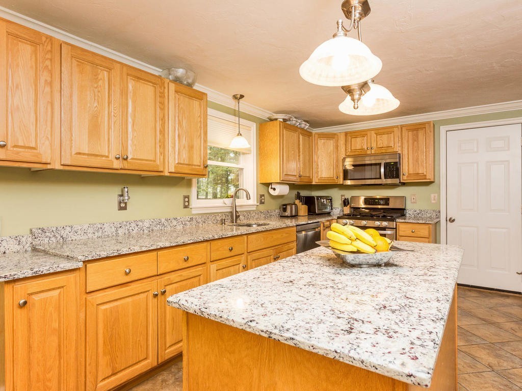 11 Rivers Edge Drive Rowley, MA 01969 - Photo 3 of 24 a kitchen with stainless steel appliances granite countertop a sink stove and refrigerator