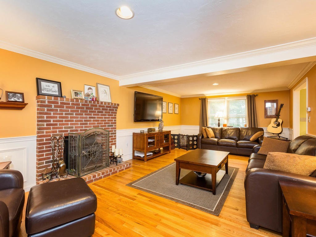 11 Rivers Edge Drive Rowley, MA 01969 - Photo 6 of 24 a living room with furniture fireplace and a flat screen tv