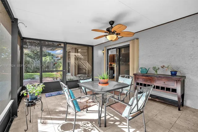a dining room with furniture a rug and a large window