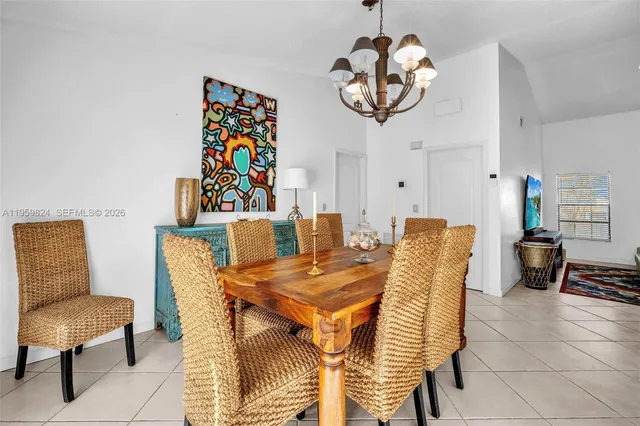 a view of a dining room with furniture and a chandelier