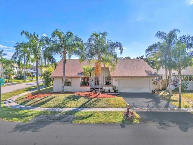 a front view of house with yard and swimming pool
