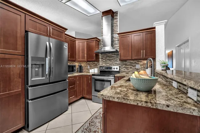a kitchen with a refrigerator and a sink
