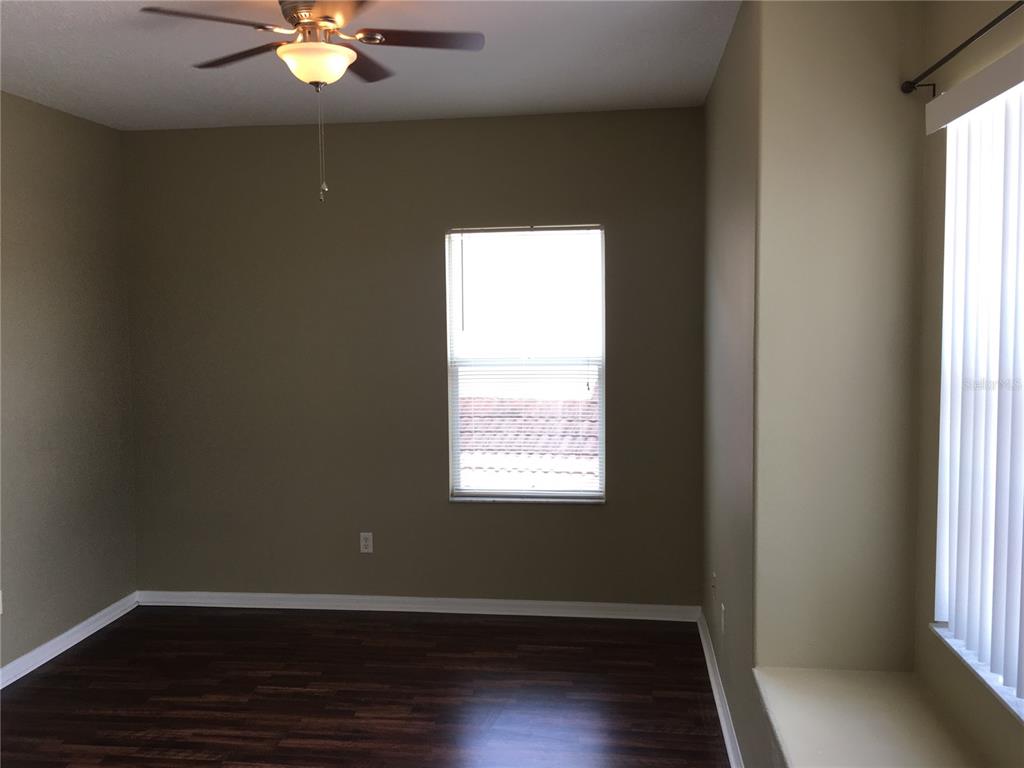 18047 Java Isle Drive Tampa, FL 33647 - Photo 17 of 21 a view of an empty room with wooden floor and a window