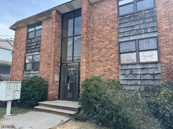 a brick building with a window and a door