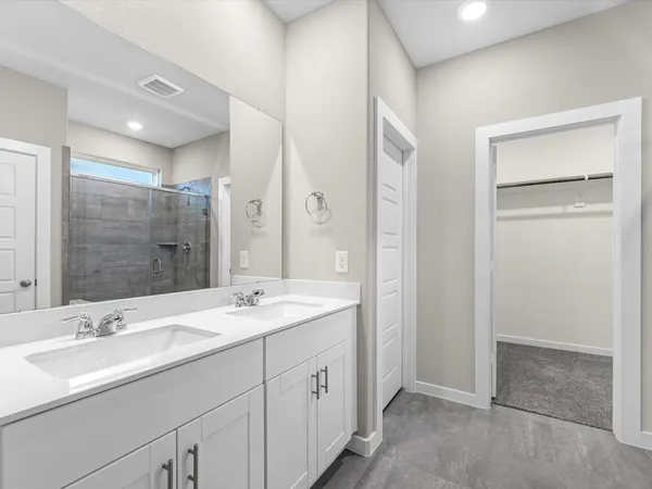 a spacious bathroom with a double vanity sink mirror and