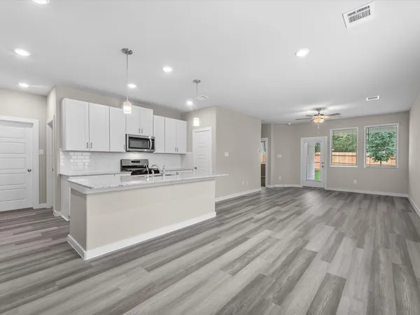a view of kitchen with granite countertop cabinets and wooden floor