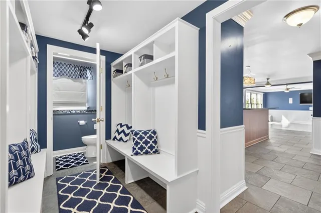 a bathroom with a sink mirror vanity and toilet