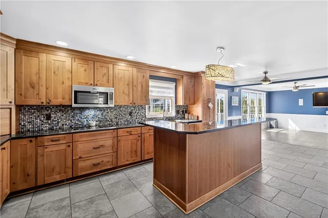 a kitchen with stainless steel appliances granite countertop a stove and a refrigerator