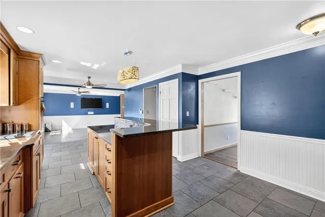 a kitchen with stainless steel appliances granite countertop a refrigerator and a stove top oven