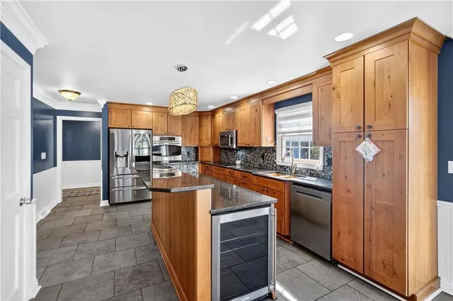 a kitchen with stainless steel appliances granite countertop a stove and a sink