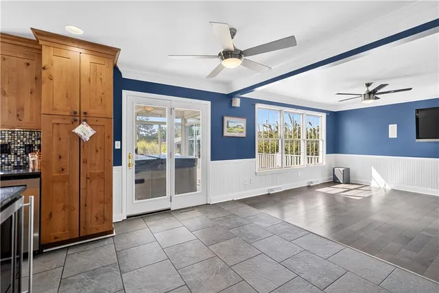 a kitchen with granite countertop a refrigerator a stove top oven and a sink