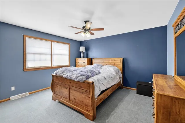 a bedroom with a large bed and a window