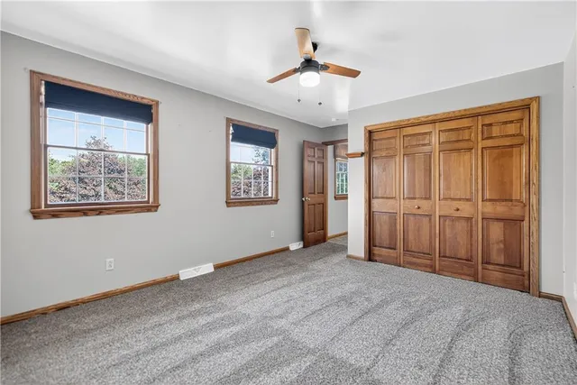 a living room with furniture a ceiling fan and a rug