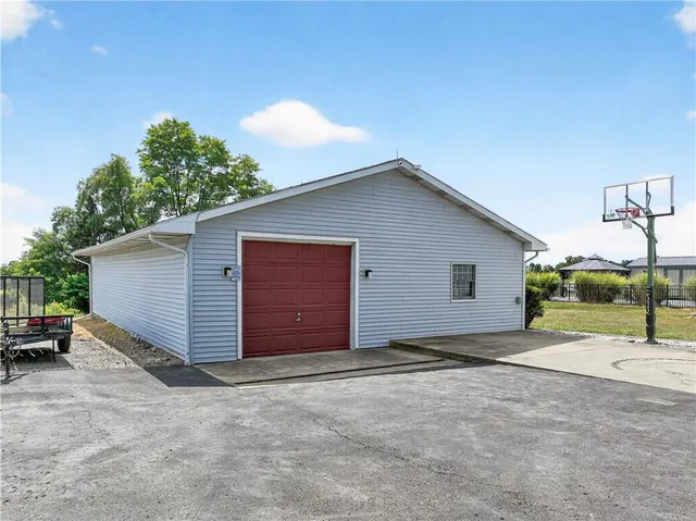 a view of a house with a yard and garage