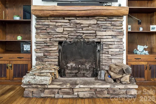 a view of fireplace with wooden floor
