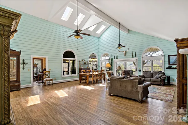 a living room with fireplace furniture and a wooden floor