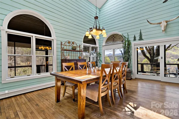 a dining room with furniture window and wooden floor
