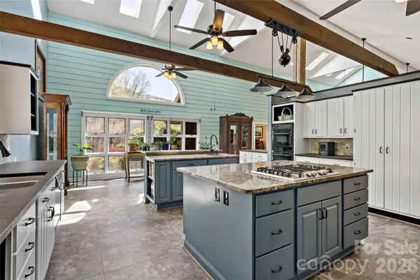 a kitchen with stainless steel appliances granite countertop a sink and cabinets
