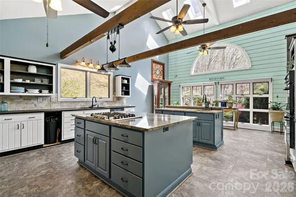 a kitchen with stainless steel appliances granite countertop a sink and stove