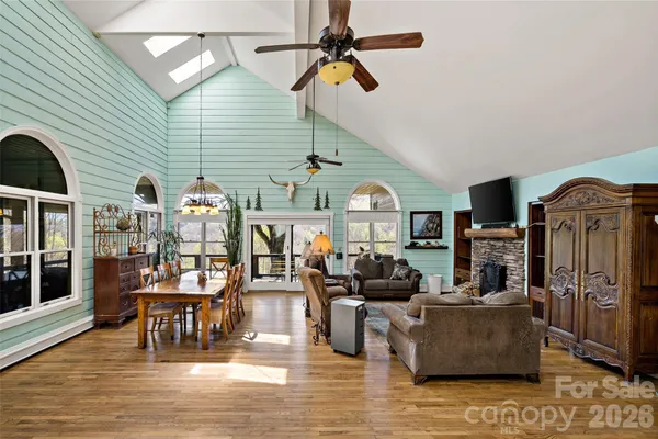 a living room with fireplace furniture and a wooden floor