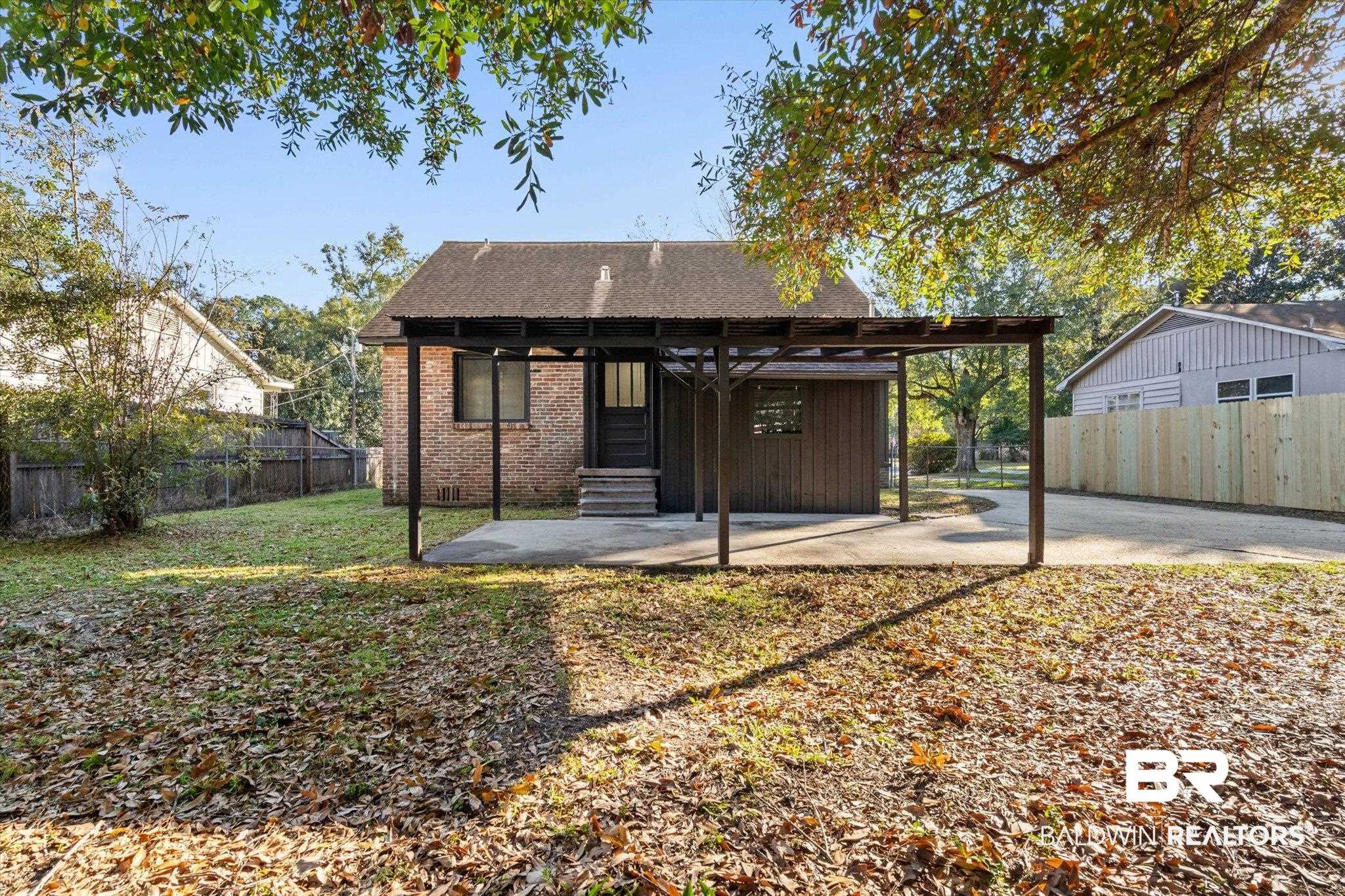 2806 Exter Drive Mobile, AL 36606 - Photo 19 of 24 Back of property featuring a fenced backyard, a patio area, brick siding, roof with shingles, and entry steps