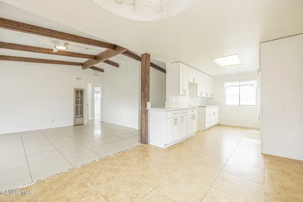 a large white kitchen with a sink