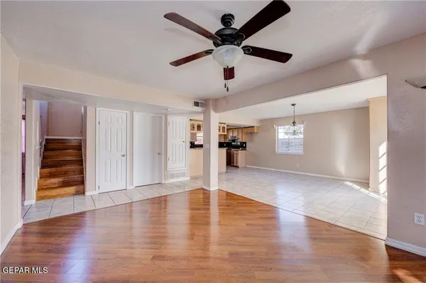 a view of empty room with wooden floor and window