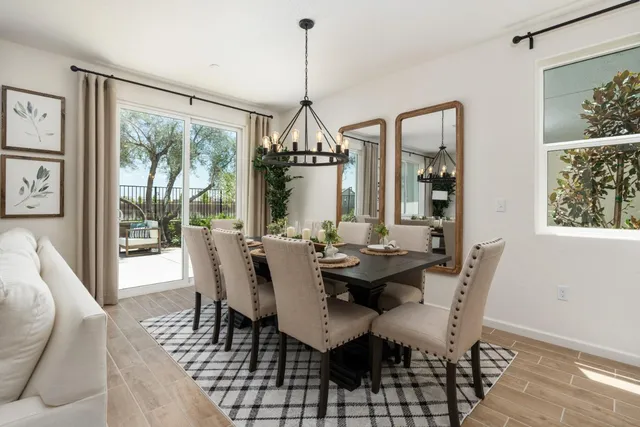 a dining room with furniture a chandelier and wooden floor