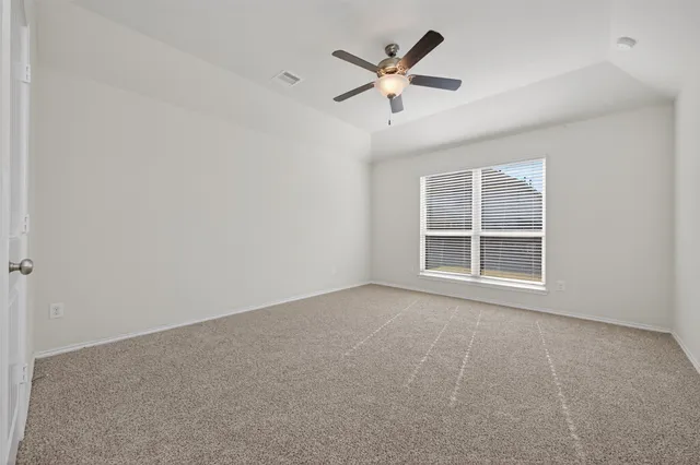an empty room with fan and a ceiling fan
