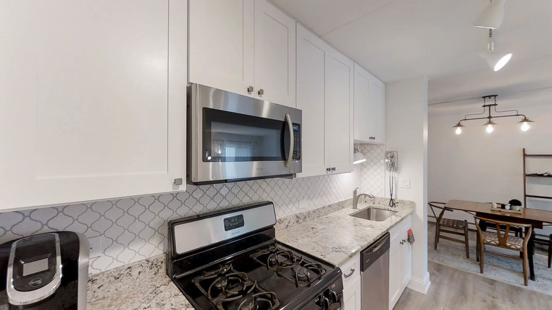 1041 North Mill Street, Unit 203 Naperville, IL 60563 - Photo 11 of 18 a kitchen with a stove and a microwave