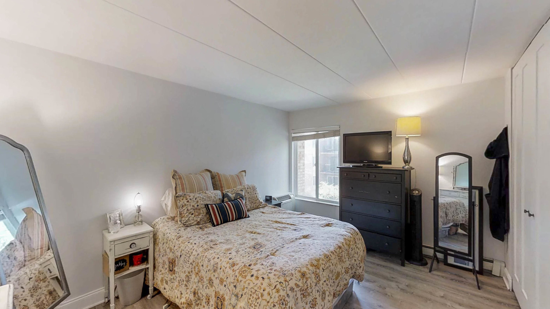 1041 North Mill Street, Unit 203 Naperville, IL 60563 - Photo 15 of 18 a large bedroom with a bed and a flat screen tv