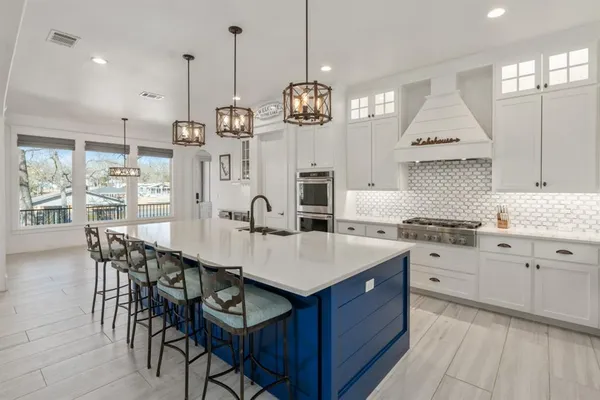 a kitchen with center island table and chairs in it