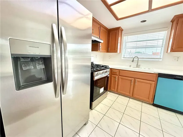 a kitchen with stainless steel appliances granite countertop a sink stove and cabinets