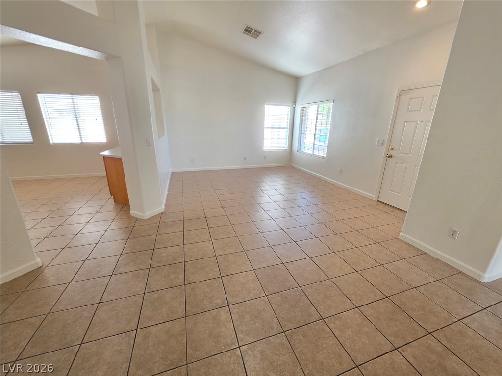 9609 Crystal Ridge Road Las Vegas, NV 89123 - Photo 7 of 21 Tiled flooring and vaulted ceilings create an open, airy feel in this main living space.