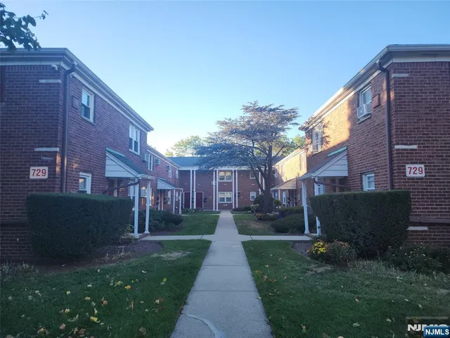 a view of a brick building next to a yard