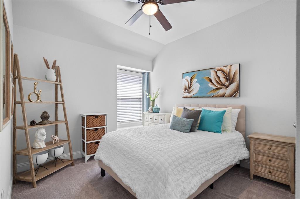 3724 Ranchers Ridge Krum, TX 76249 - Photo 19 of 32 a bedroom with a large bed and a chandelier