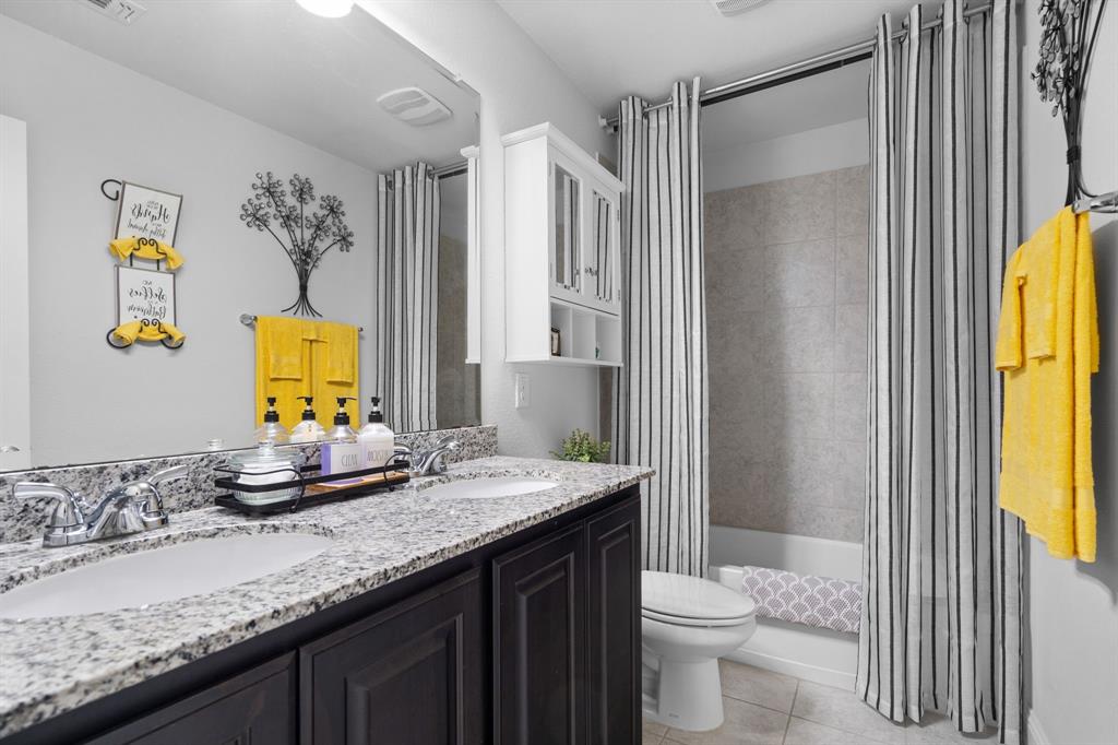 3724 Ranchers Ridge Krum, TX 76249 - Photo 20 of 32 a bathroom with a granite countertop sink a toilet and a mirror