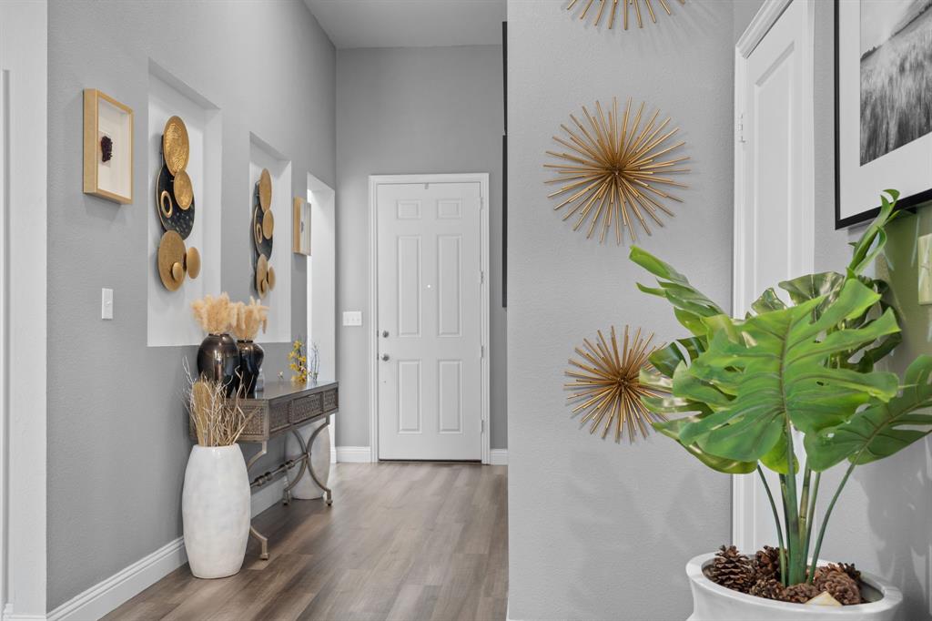 3724 Ranchers Ridge Krum, TX 76249 - Photo 6 of 32 a vase of flowers sitting on a table with wooden floor