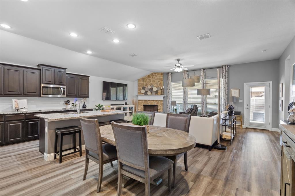 3724 Ranchers Ridge Krum, TX 76249 - Photo 32 of 32 a view of a dining room with furniture a kitchen and chandelier