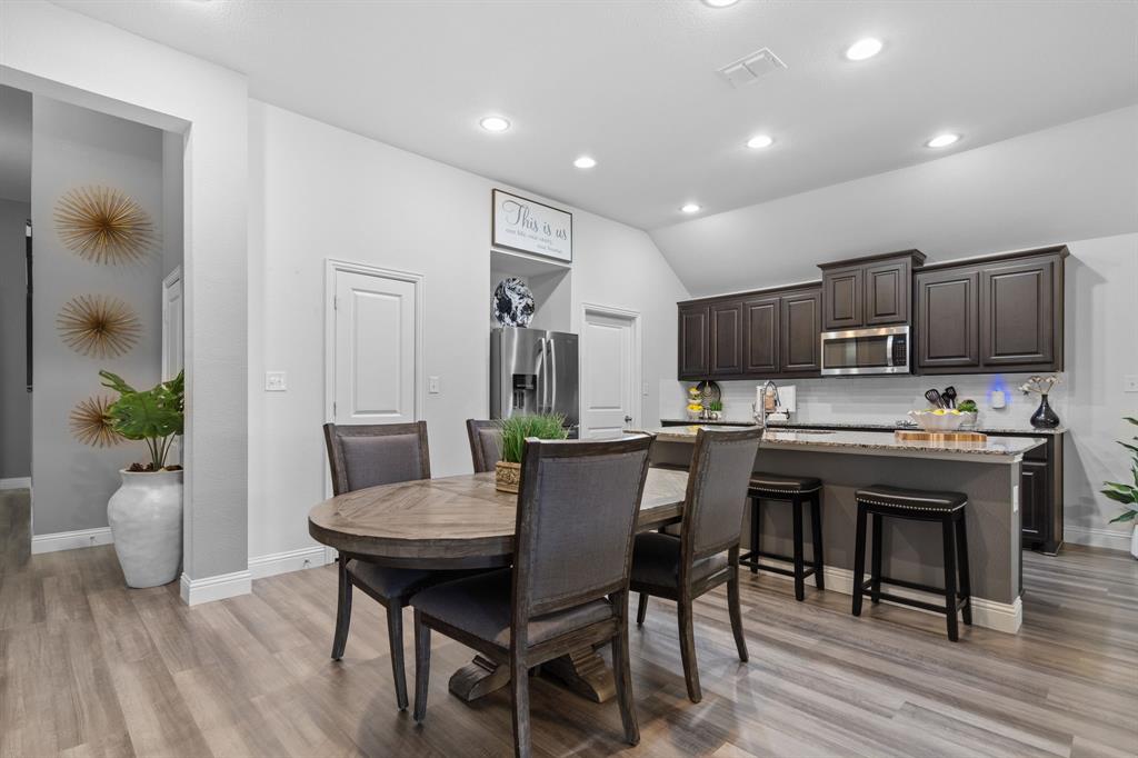3724 Ranchers Ridge Krum, TX 76249 - Photo 7 of 32 a kitchen with a table and chairs in it
