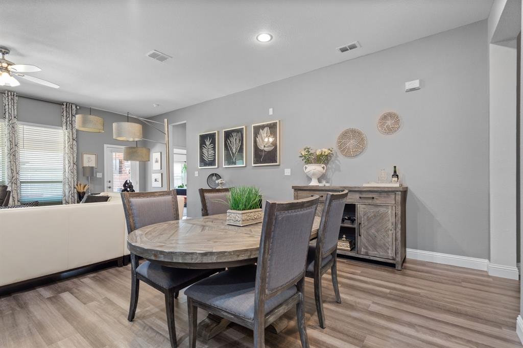 3724 Ranchers Ridge Krum, TX 76249 - Photo 8 of 32 a view of a dining room with furniture and wooden floor
