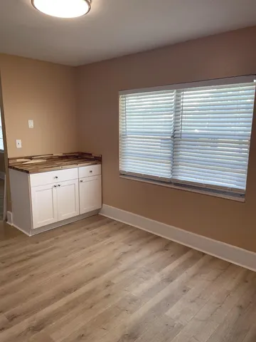 a view of a kitchen with granite countertop cabinets a sink and a dishwasher