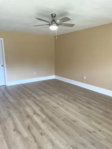 a view of a room with wooden floor
