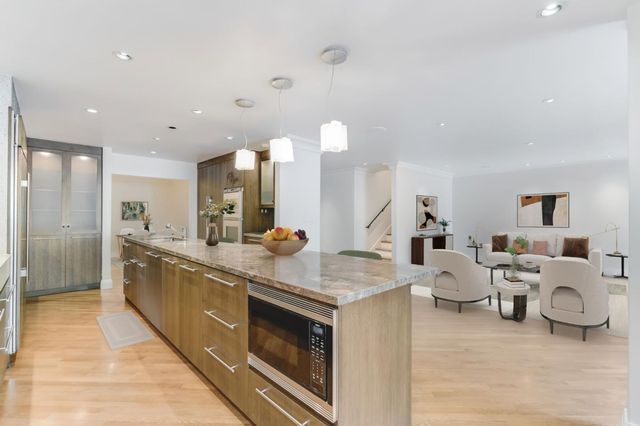 a large white kitchen with lots of counter space