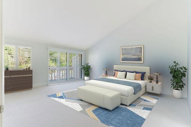 a bedroom with a large bed and a chandelier