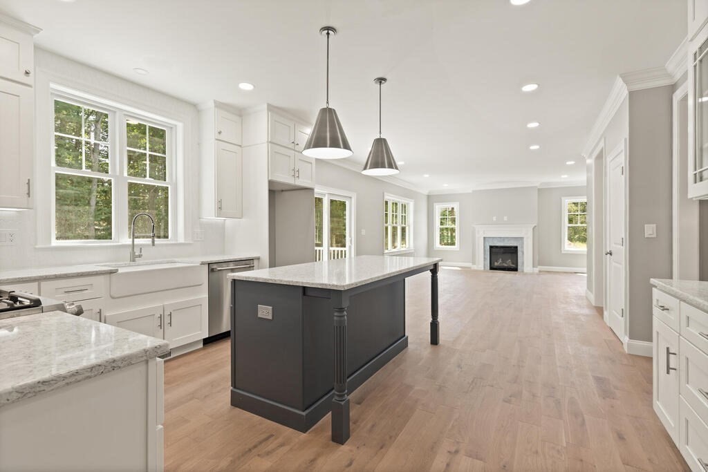 15 Lawler Lane Stoughton, MA 02072 - Photo 11 of 41 a kitchen with stainless steel appliances granite countertop a sink a stove and a wooden floors